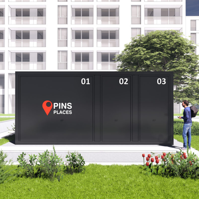 Wizualizacja czarnego kontenera magazynowego Pins Places z trzema oznaczonymi wejściami 01, 02, 03 na tle bloków mieszkalnych